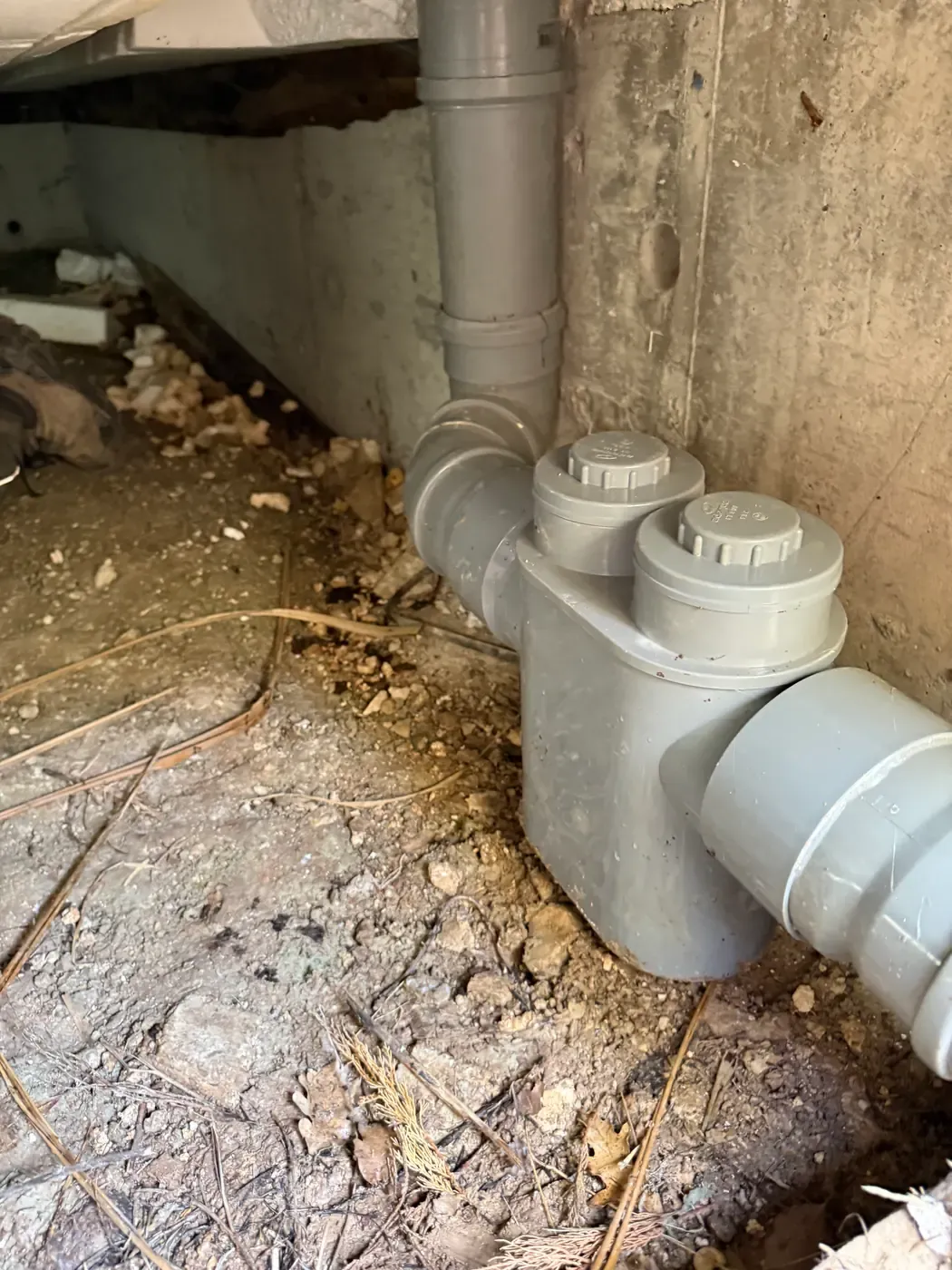Vue rapprochée d’un siphon disconnecteur avec ses deux bouchons sur le réseau d’assainissement à Opio